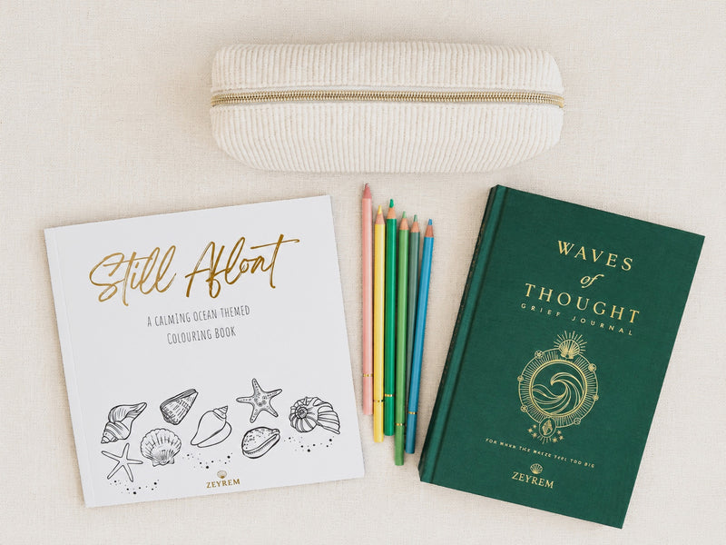 Waves of Thought grief journal, Still Afloat colouring book and coloured pencils in a corduroy pouch, a grief care package from Zeyrem Australia
