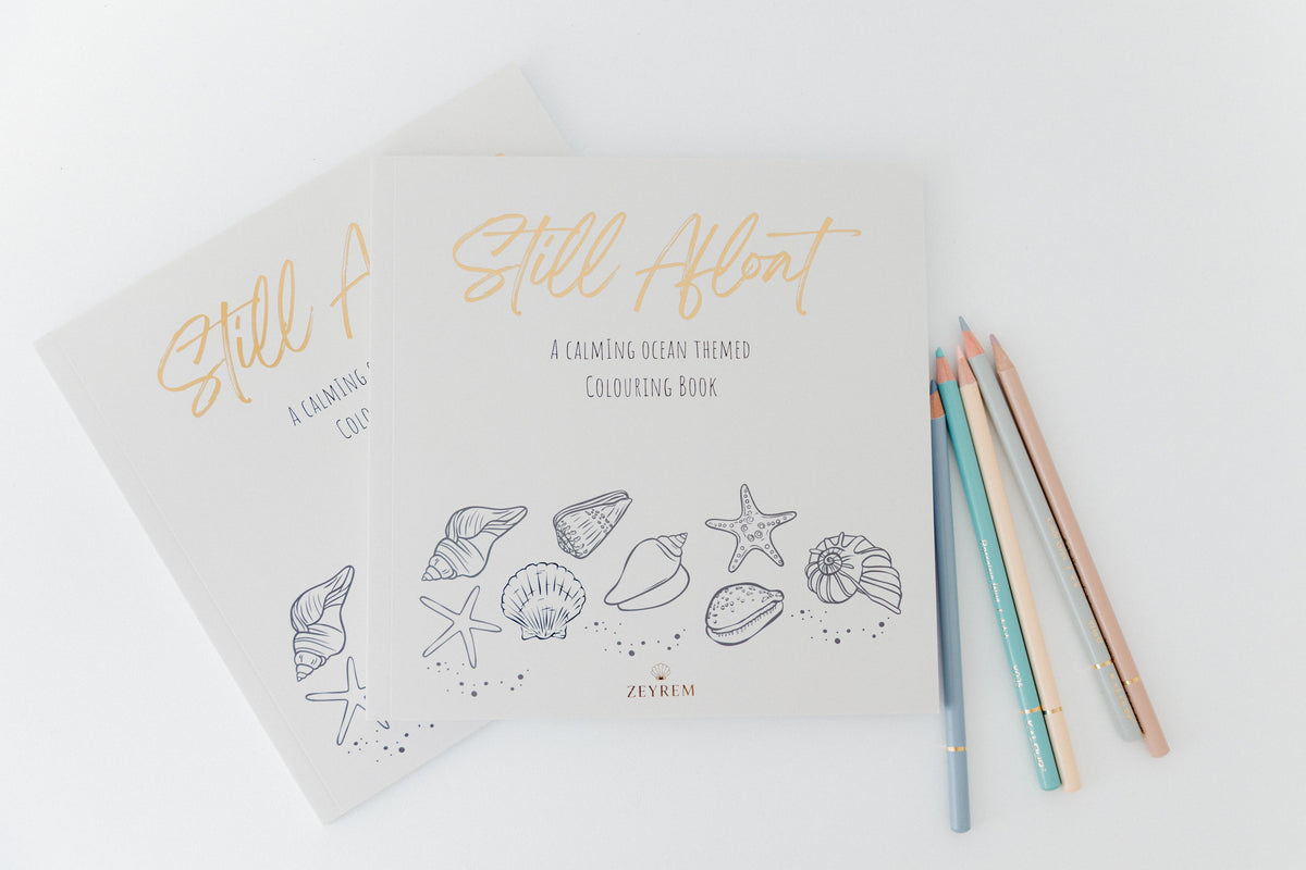 Two Still Afloat ocean colouring books with pastel coloured pencils, the grief colouring book bundle