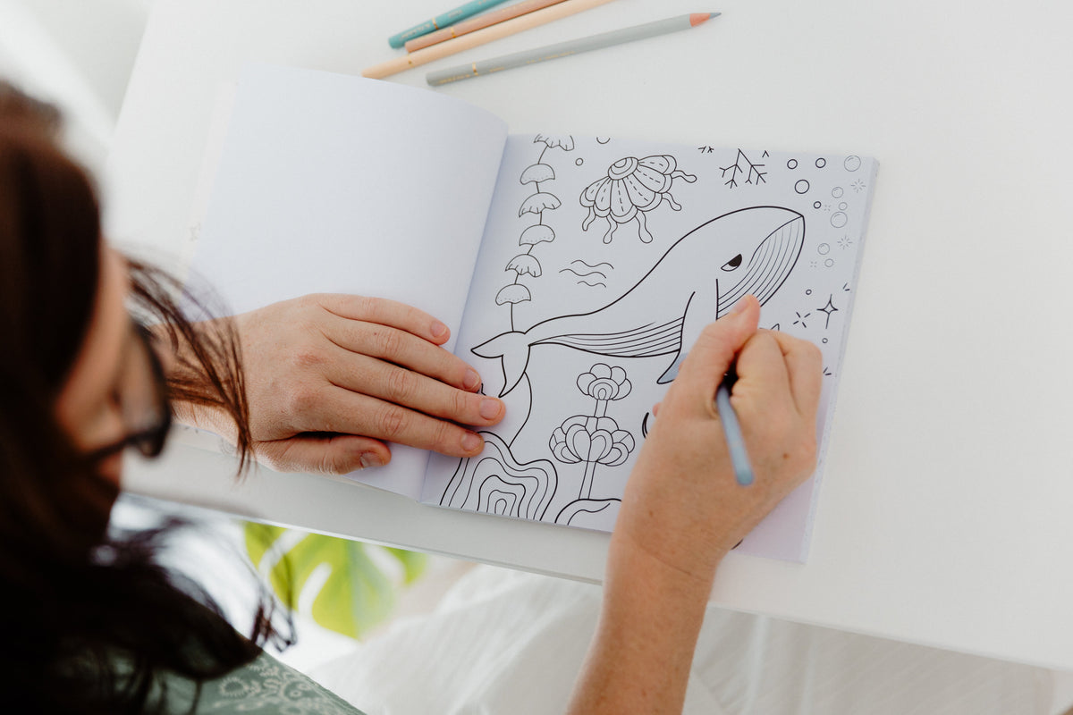 Colouring a whale page inside the Still Afloat book, art therapy for grief and bereavement