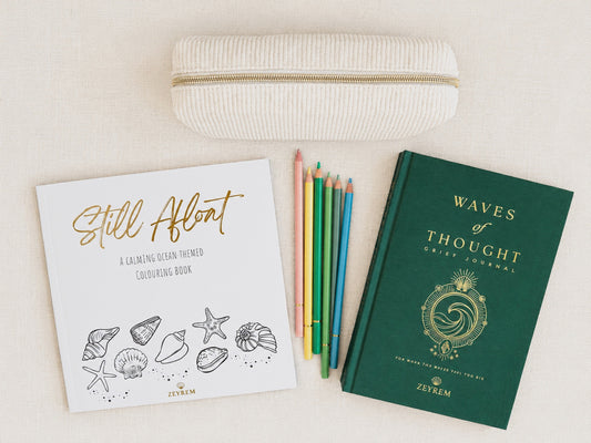 Waves of Thought grief journal, Still Afloat colouring book and coloured pencils in a corduroy pouch, a grief care package from Zeyrem Australia
